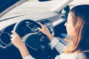 Close up of a girl driving a car